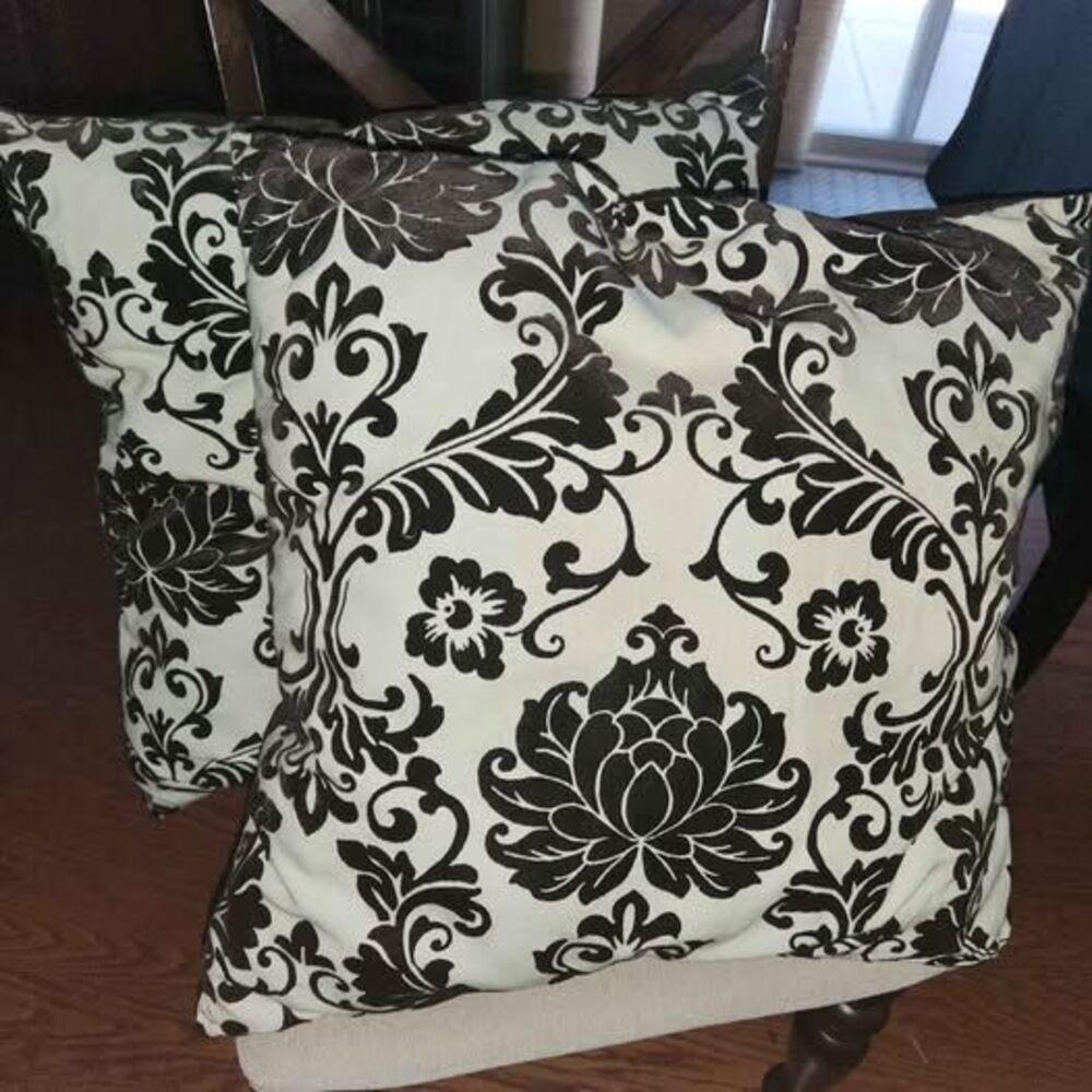Two brown damask pillows